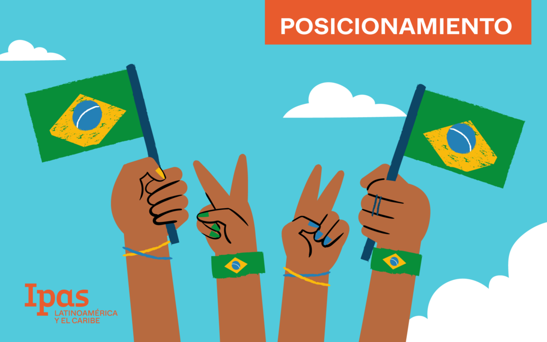 Various hands holding Brazilian flags against a blue sky with clouds in the background